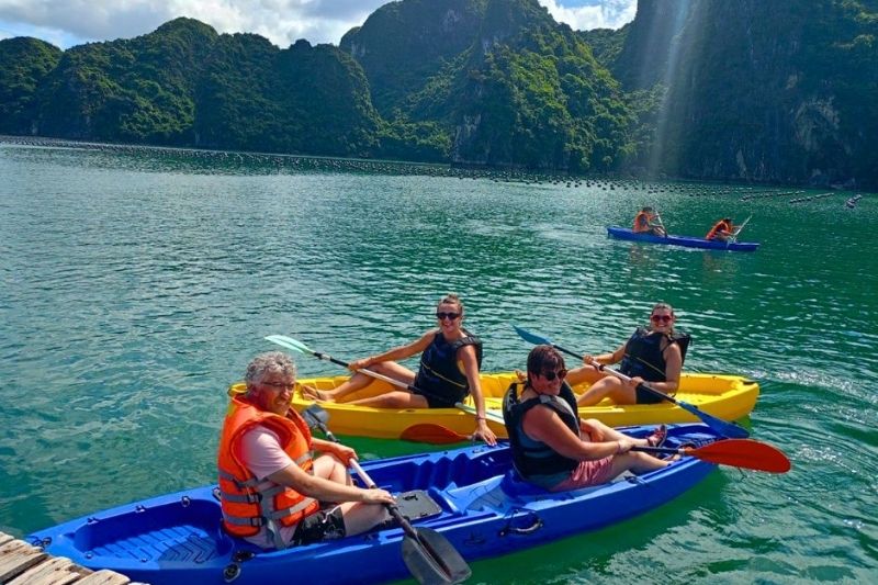 Kayaking through a tunnel cave lagoon in Halong Bay