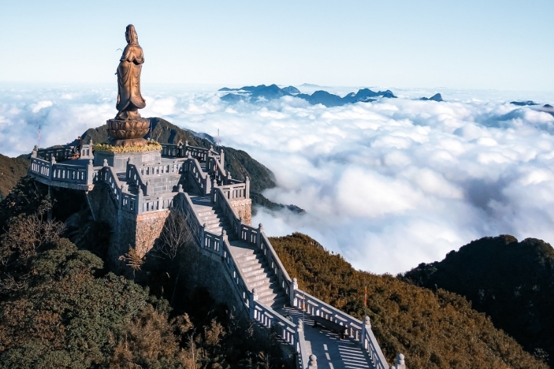 The majestic stone path leading to the giant Great Buddha Statue and Kim Son Bao Thang temple complex built into the sheer, cloud-swept cliffs of Fansipan.