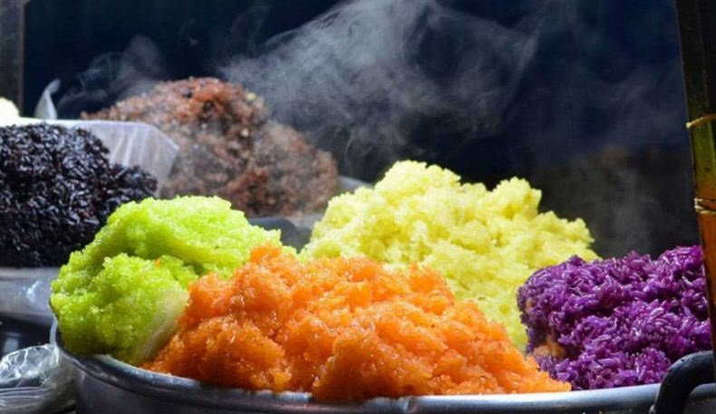Seven-Colored Sticky Rice: The Culinary Essence of Nung People A colorful platter of five- to seven-colored sticky rice displayed beautifully on green banana leaves in Sapa.