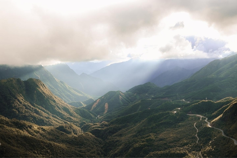 An aerial landscape view of the Ô Quy Hồ pass showing its grand mountain range stretching across Lao Cai and Lai Chau provinces.
