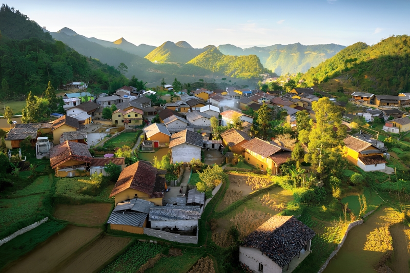 Lo Lo Chai Village with earthen houses and terraced fields at the foot of Rong Mountain